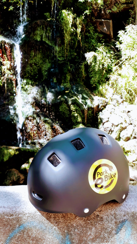 Parkebike helmet with pretty waterfall in the background 