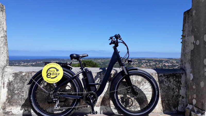 Ebike parked with a view to the Atlantic ocean in Sintra Portugal
